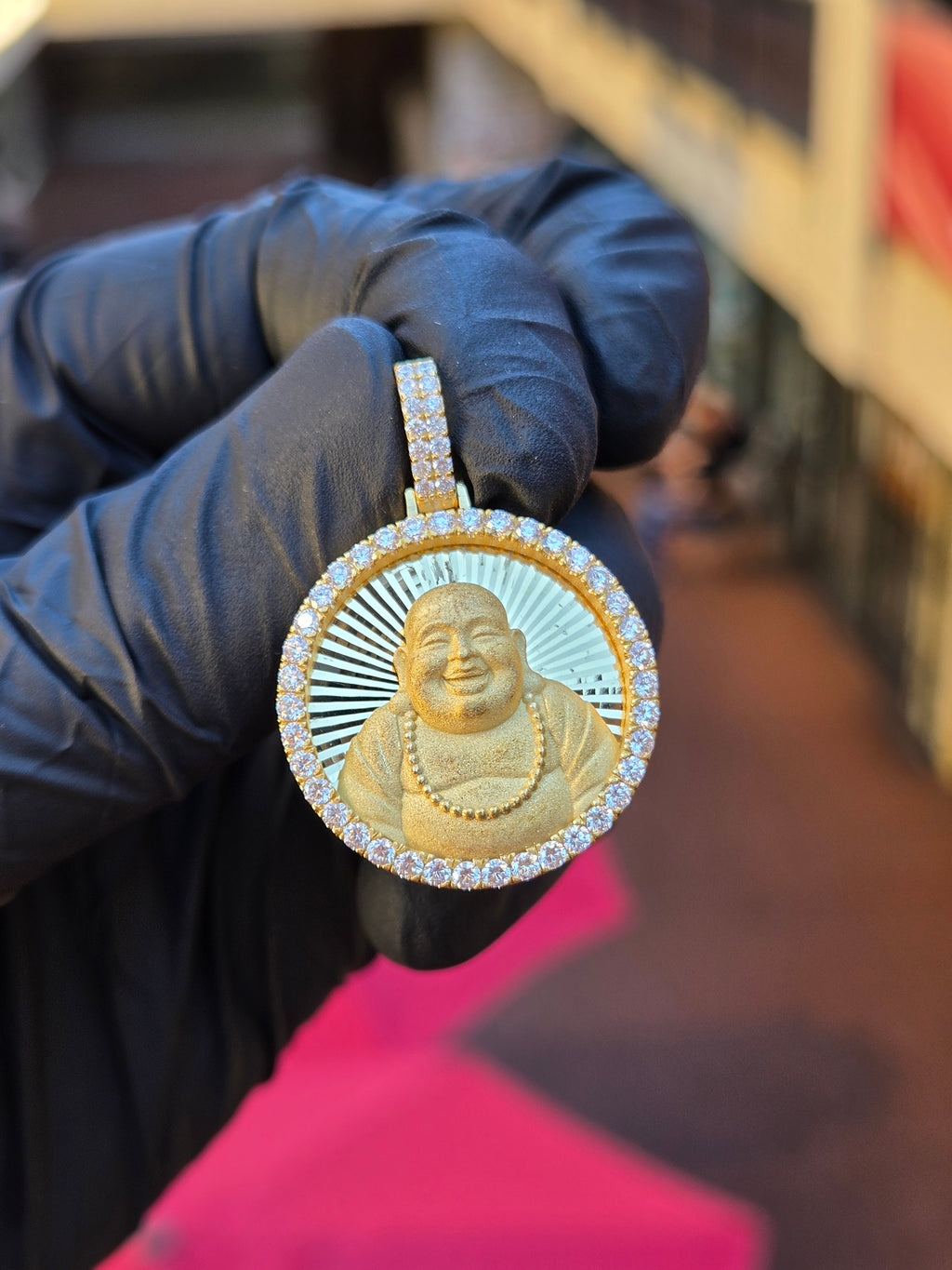 Happy Buddha Circular diamond pendant, laughing Budai in sandblasted relief on a diamond-cut ray field inside 52 framing stones