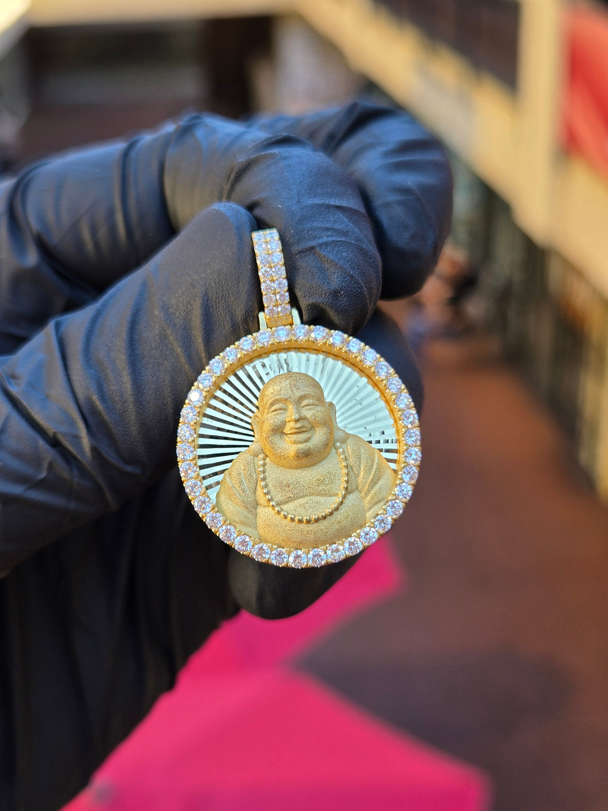 Happy Buddha Circular diamond pendant, laughing Budai in sandblasted relief on a diamond-cut ray field inside 52 framing stones