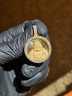 Happy Buddha medallion in warm light, the beaded mala falling across the open robe and the relief throwing its own shadow