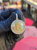 Jesus Circular diamond pendant, the bust of Christ in sandblasted relief on a diamond-cut ray field inside 52 framing stones