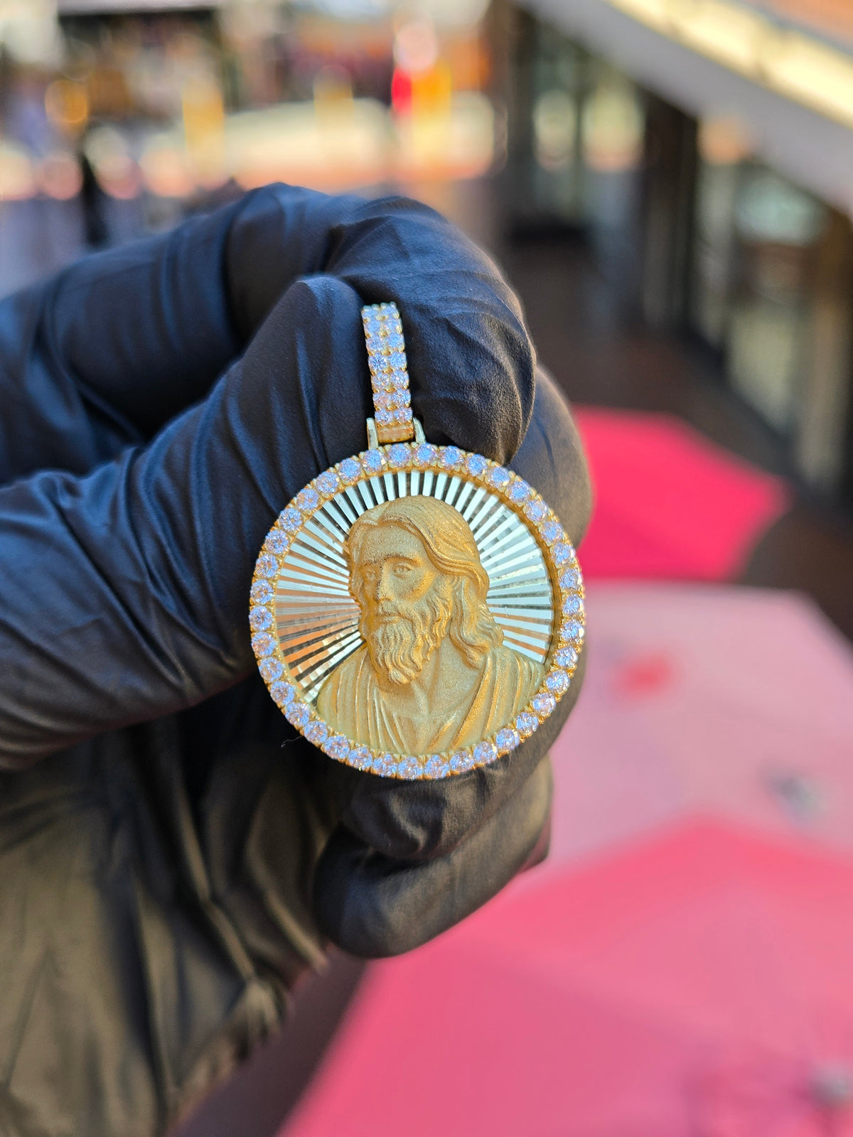 Jesus Circular diamond pendant, the bust of Christ in sandblasted relief on a diamond-cut ray field inside 52 framing stones