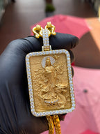 Yellow gold Lady Buddha (Guan Yin) Diamond Framed Pendant, a deep-relief rectangular plaque of Guan Yin standing on a lotus, framed on all four sides by round diamonds.