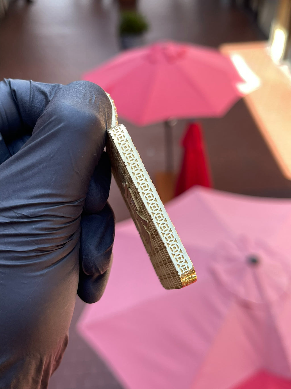 Edge view of the Lady Buddha (Guan Yin) Diamond Framed Pendant showing the key-fret pattern cut into the side wall and the thickness of the plaque.