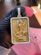 Full front view of the Lady Buddha (Guan Yin) Diamond Framed Pendant held in daylight, showing the complete diamond frame and the multi-row pave bail. Chain not included.
