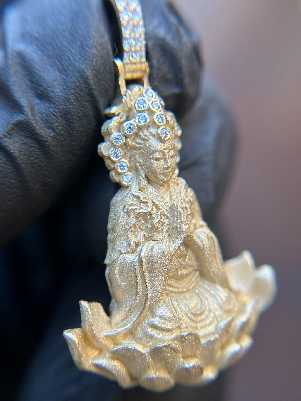 Three-quarter view of the Lady Buddha (Guan Yin) Partial Diamond Pendant showing the sculpted robe folds and full-petal lotus relief.