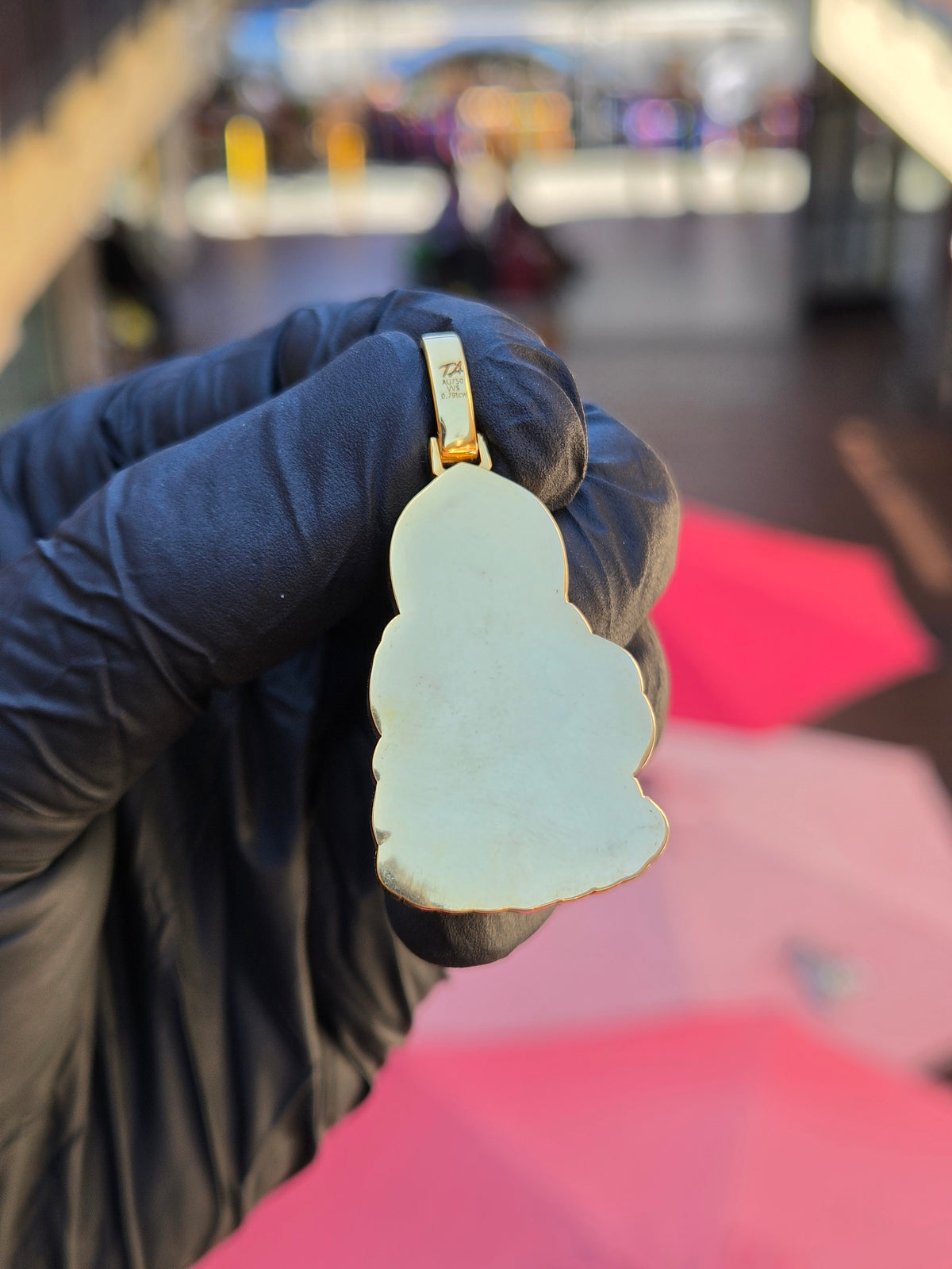 Plain mirror-polished back of the Guan Yin Riding a Dragon pendant, following the same lotus-bud outline, with the bail stamp