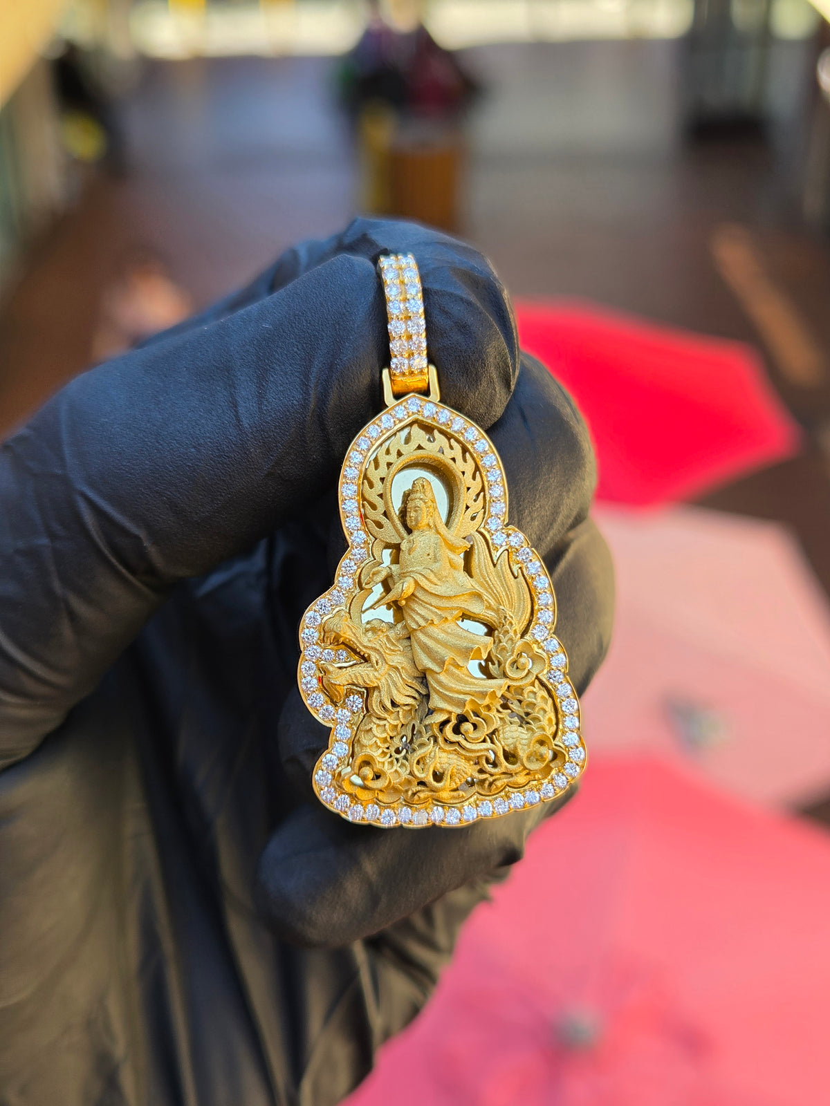 Guan Yin seated side-saddle on a coiling dragon in frosted gold relief, cloud scrolls below and a double polished halo behind her head
