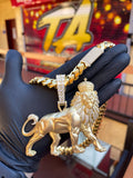 Yellow gold Large Lion Partial Diamond Pendant, a standing lion in satin gold with the mane, crown and tail tip pave-set in diamonds, shown on a Cuban link chain.