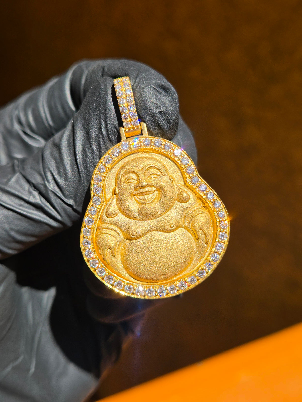 Medium Happy Buddha gold pendant in sunlight, calabash outline with a sandblasted Budai relief and a row of large round diamonds