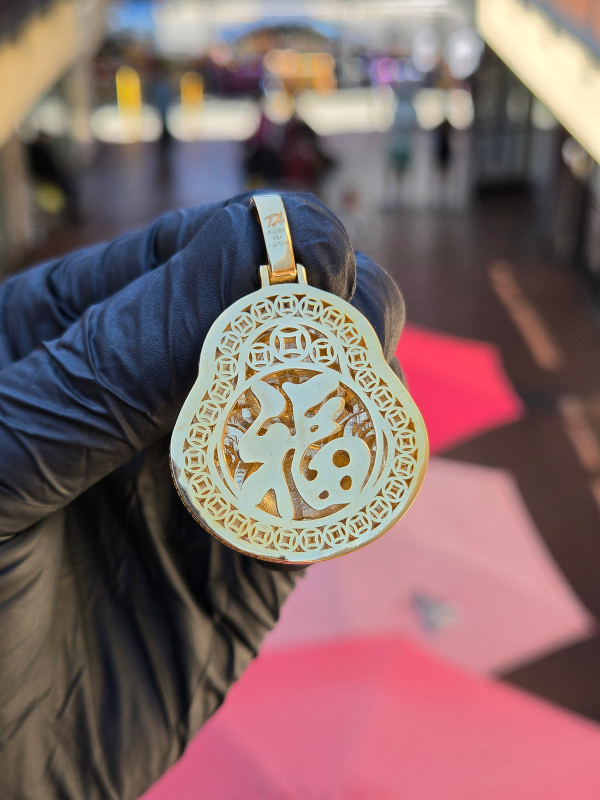 Openwork back of the Medium Happy Buddha pendant, the fu character ringed by two courses of pierced Chinese cash coins