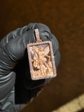 Saint Michael Archangel gold pendant in sunlight, full wingspan over a diamond-cut ray field inside a frame of large round diamonds