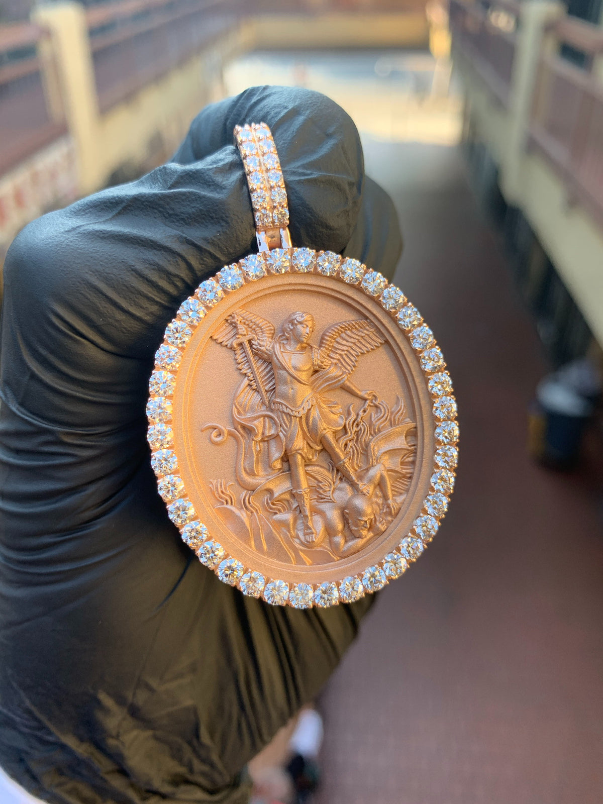 Yellow gold Saint Michael Archangel Diamond Oval Pendant, a deep-relief oval medallion on a sandblasted field framed by large prong-set round diamonds.