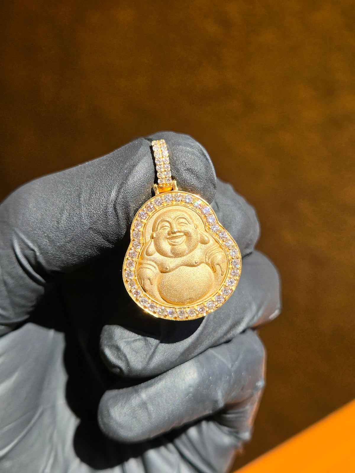 Small Happy Buddha gold pendant in sunlight, calabash gourd outline with a frosted Budai relief inside a full single row of round diamonds