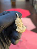 Angled view of the Small Virgin Mary Face pendant showing the deeply undercut veil and the fixed six-diamond bail