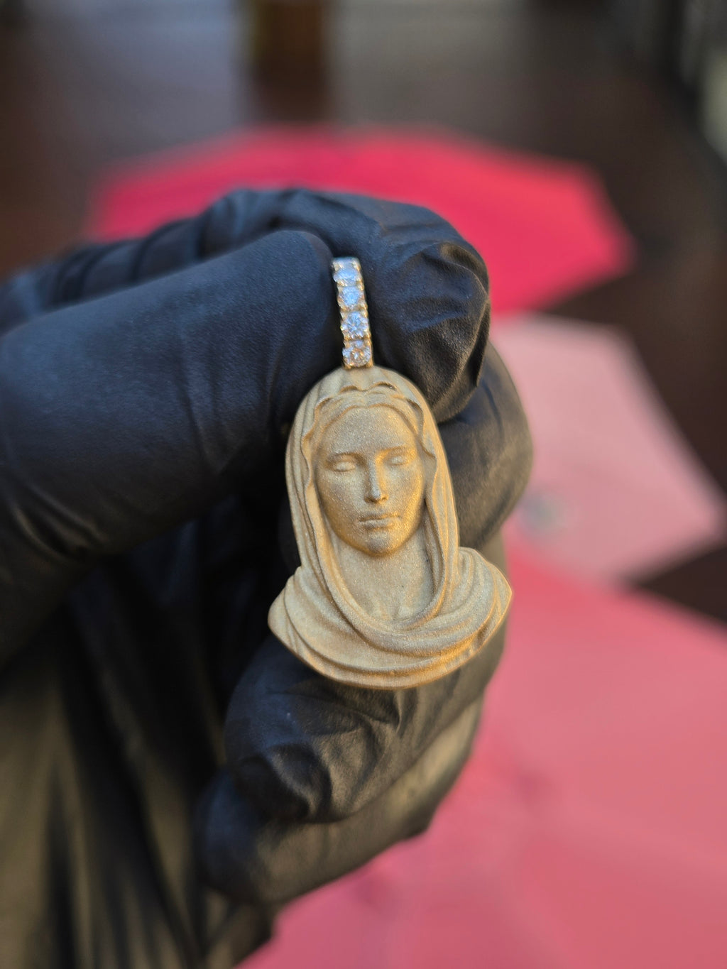 Virgin Mary bust pendant finished entirely in sandblasted matte gold, eyes closed, with no polished surface on the body of the piece