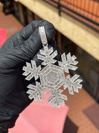 White gold Snowflake Diamond Pendant, six arms built from channel-set emerald-cut diamonds outlined in round diamonds, on a baguette-set bail.