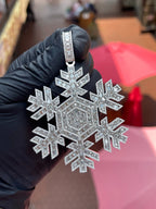 Angled view of the Snowflake Diamond Pendant showing the open gaps between the arms and the hexagonal emerald-cut centre panel.