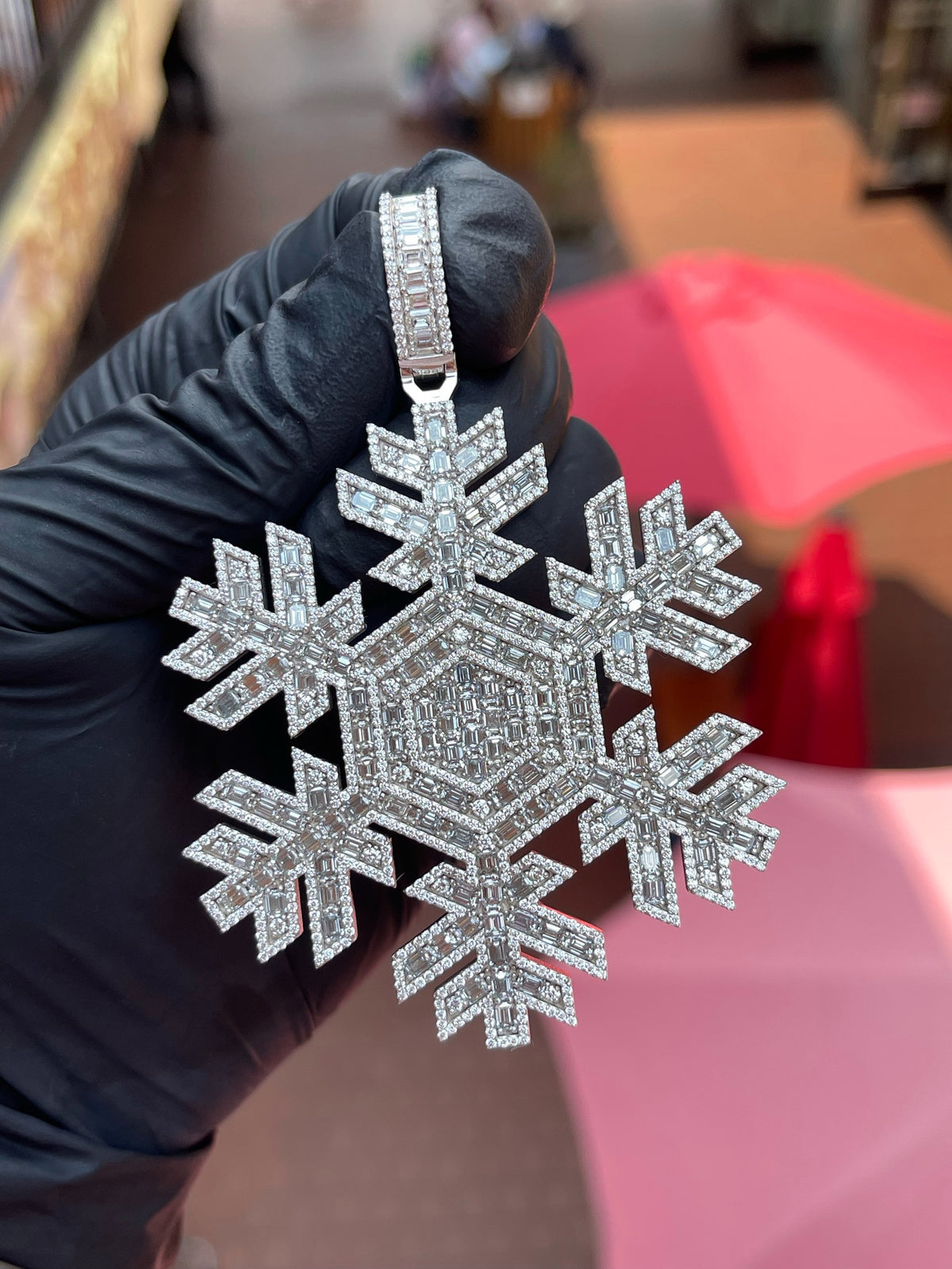 Angled view of the Snowflake Diamond Pendant showing the open gaps between the arms and the hexagonal emerald-cut centre panel.
