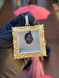 Yellow gold Square Filigree Memorial Diamond Pendant, a carved scrollwork border around a diamond-framed glazed photo window on a two-row pave bail. The photo shown is an example and can be replaced with any image.