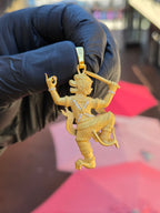 Thai Hanuman pendant held to show the bail, with the crossed diamond chest bands and engraved spiral ornament across the body